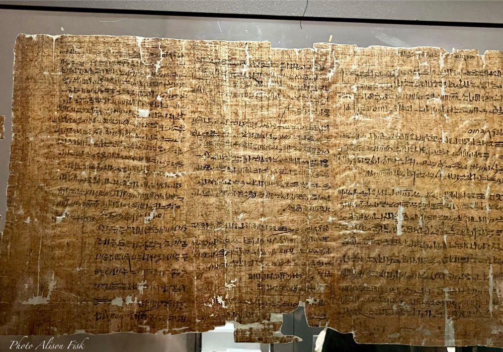My photo shows the front side (recto) of an ancient Egyptian administrative document written by the scribe Amunnakht in hieratic script (cursive writing of hieroglyphics) using black ink on papyrus. The papyrus is now a mid-brown colour and is worn in places.

The document is known as the ‘Strike Papyrus’ and recounts that in November of Year 29 of the reign of Ramesses III, the royal tomb workers of Deir el-Medina stopped work for the first time and spent several days at the Theban necropolis in the temples of Tuthmosis III and Ramesses II. They demanded that the grain ratians for their work be distributed, and the authorities subsequently disbursed the grain rations. However, a few days later, the workers went on strike again, this time finding refuge in the temple of Seti I. Their refusal to retum to work stemmed fram the precarious working conditions, a situation they wanted to bring directly to the pharaoh. The last strike documented here was in January of the following year.