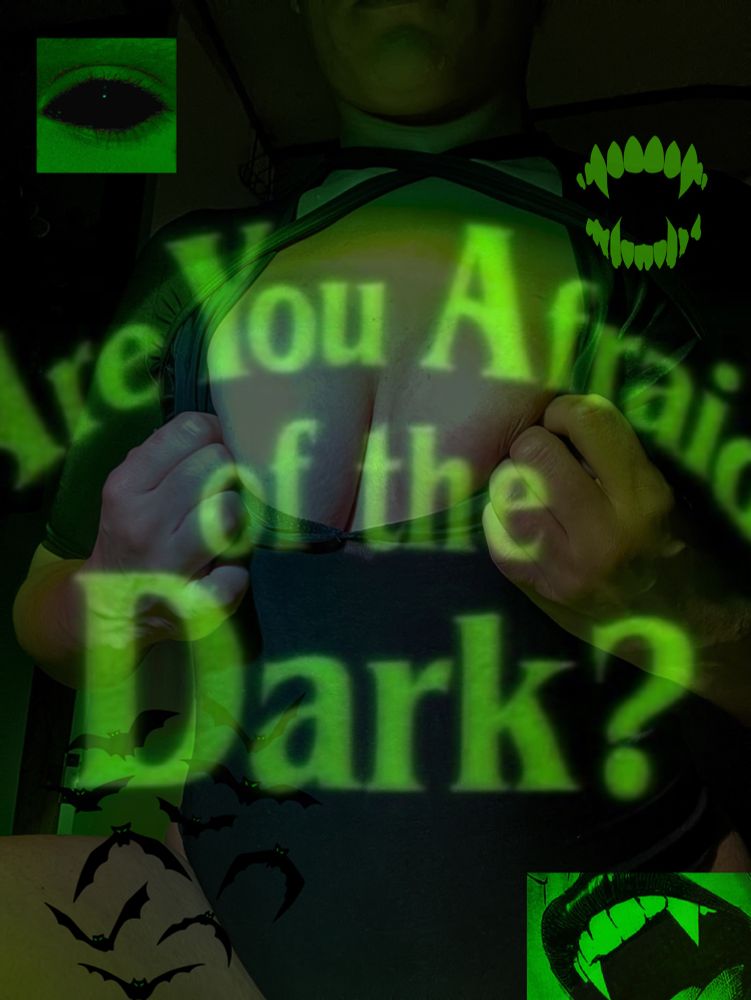 Image of Nat in a black unitard. There’s an overlay of the title “are you afraid of the dark?” In neon green on top of the photo. 
There’s bats, green fangs, the overall vibe is green vampire. 