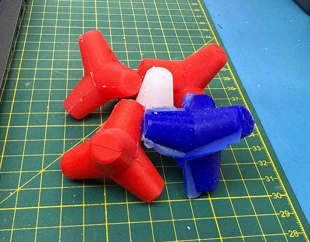 Five small silicone tetrapods in various colours