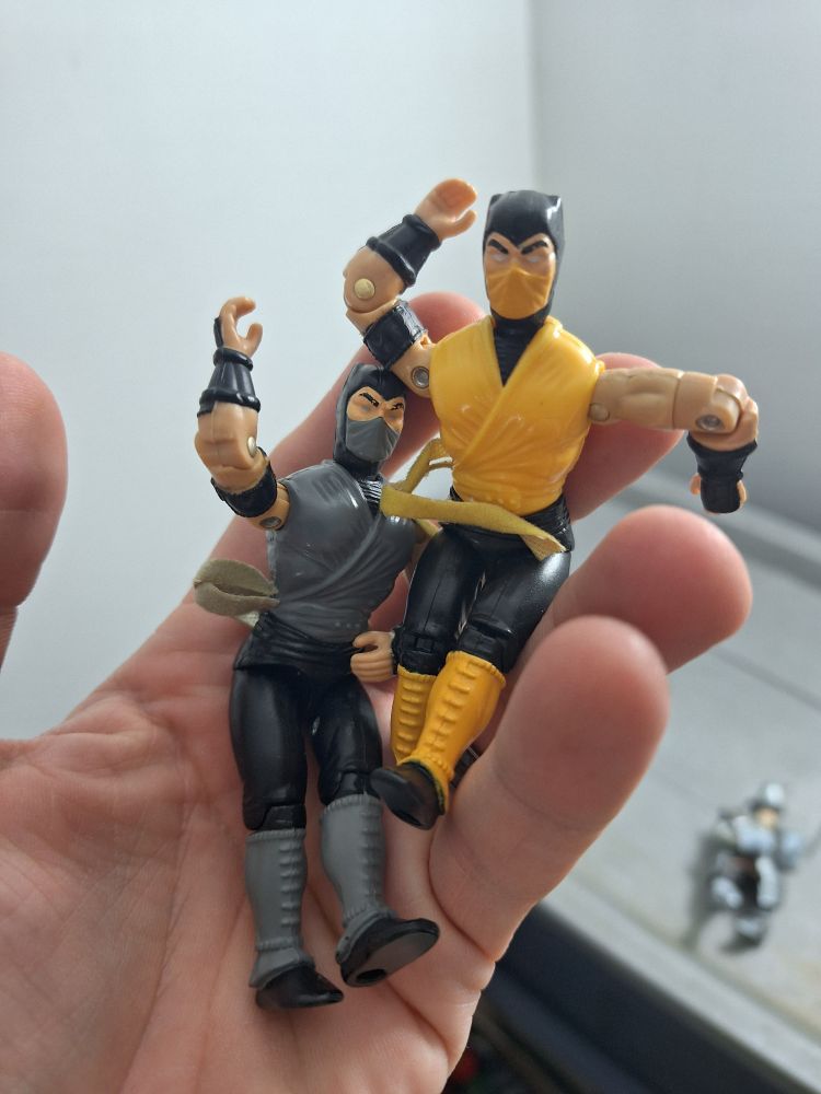 Mortal Kombat figures of Scorpion and Smoke, circa mid-90s