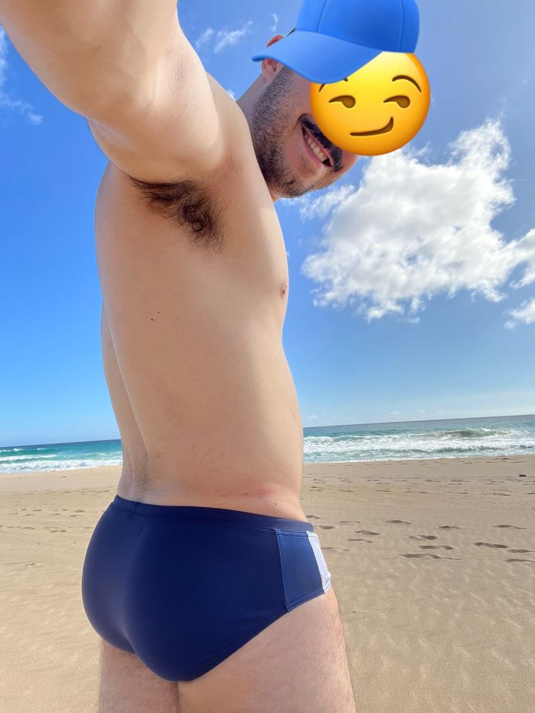blue speedo and mustache on the beach