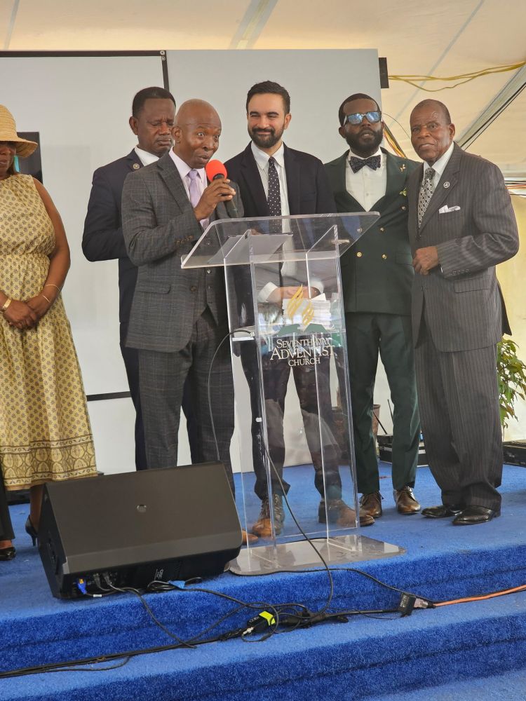 Zohran on stage surrounded by Church leaders.
