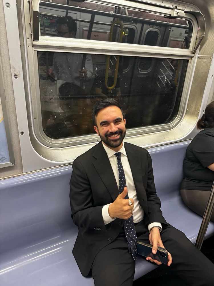 Zohran giving a thumbs up on a subway. 