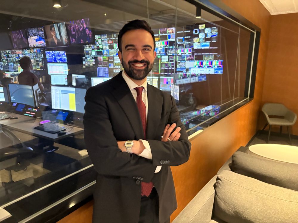 Zohran standing in front of a TV control room 