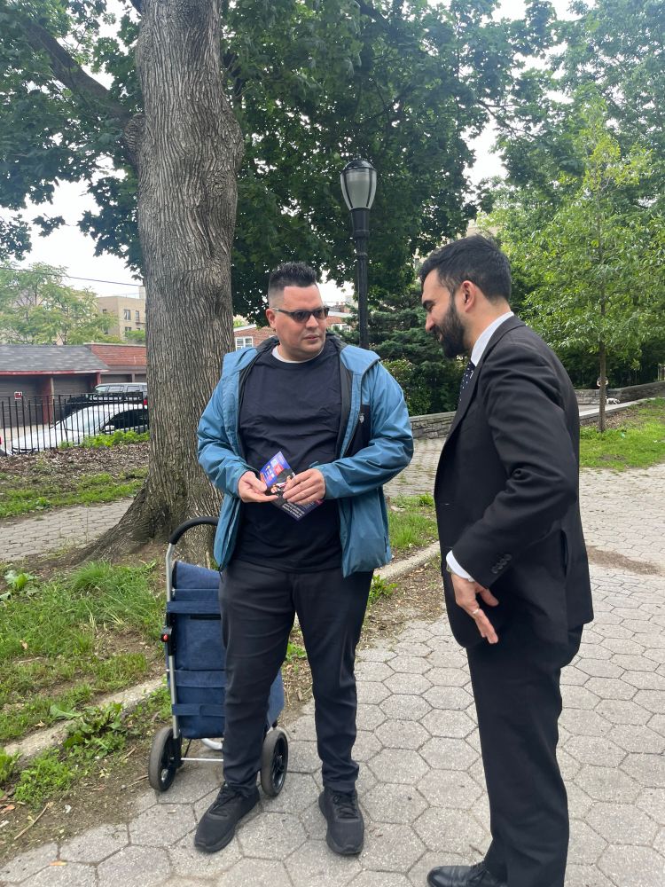 Zohran and State Senator Gustavo Rivera talking to voters in Norwood.