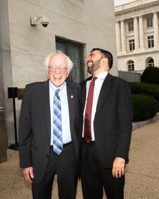 Bernie and Zohran laughing.