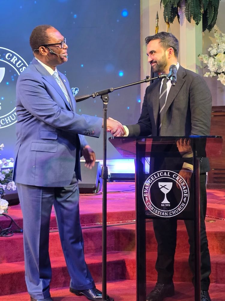 Zohran shaking hands with the Reverend at the pulpit.