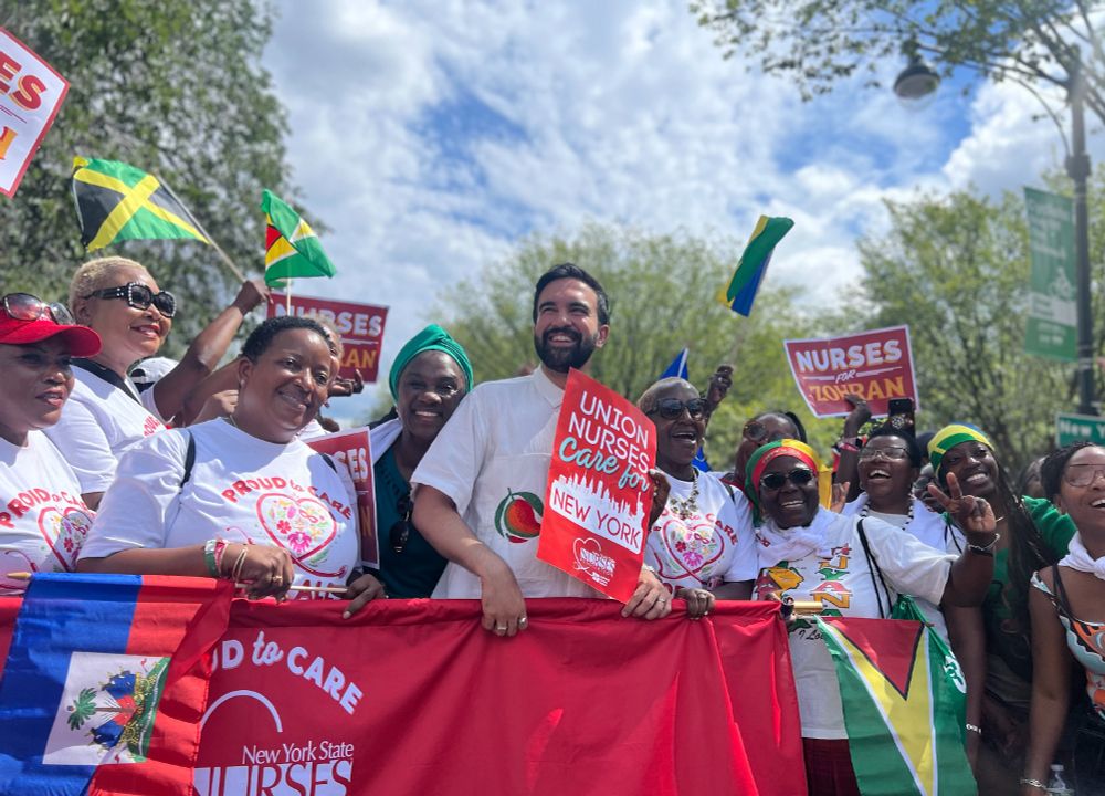 Zohran in the parade, holding a New York State Nurses Association banner with about dozen others.