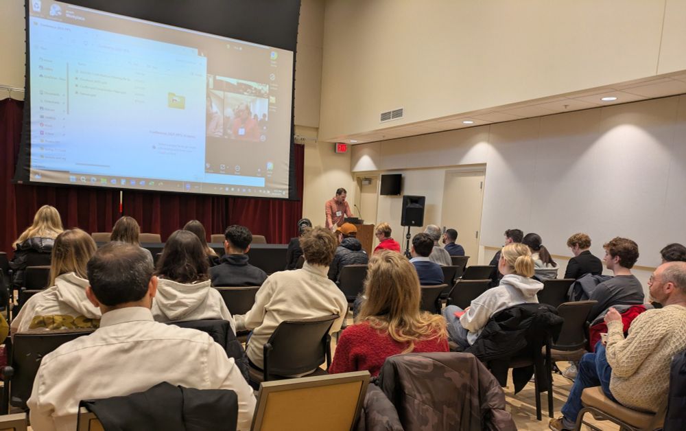 A photo of the conference attendees watching a presentation.
