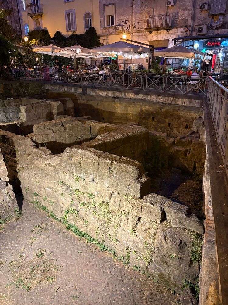 The ancient city walls of Neapolis, sunken beneath the eateries of Piazza Bellini