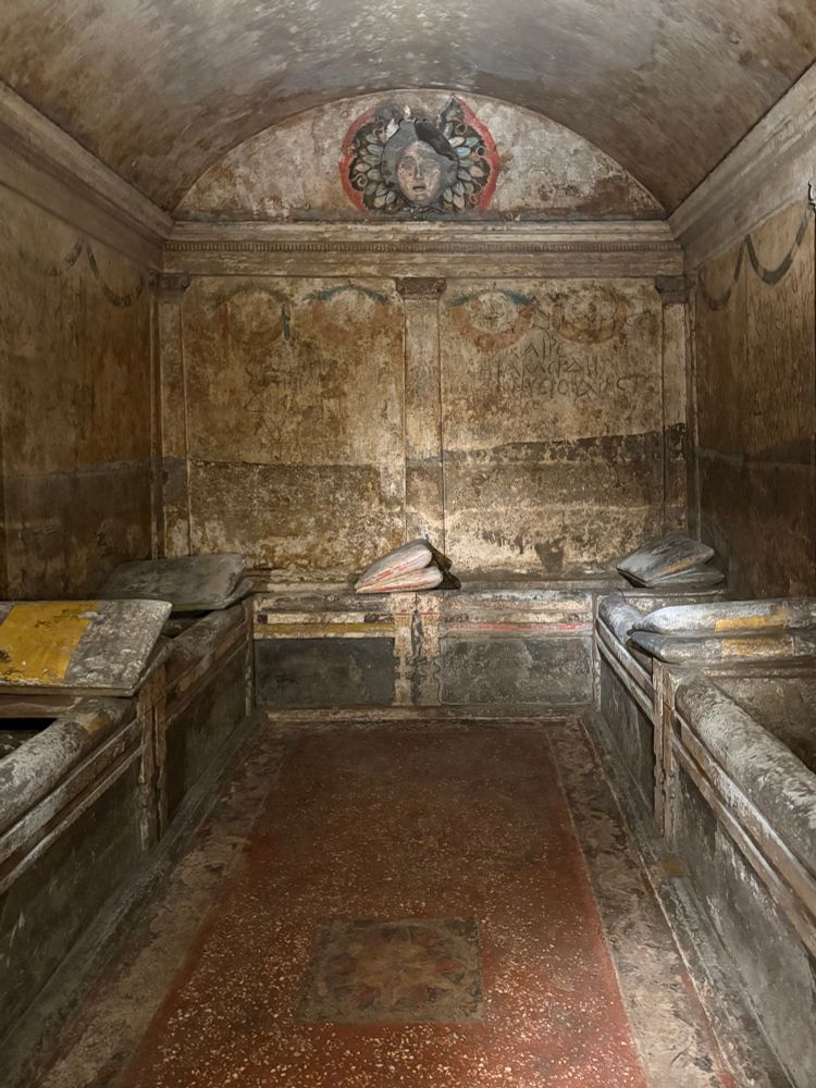 A lavishly decorated Hellenistic hypogeum, with painted walls, funerary couches (including pillows), and Medusa head. Also a lovely red cocciopesto floor.