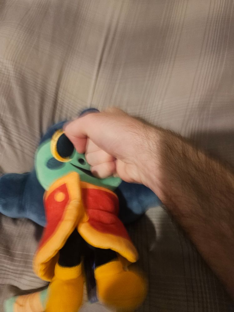 The same plush of Inspekta from the game Great God Grove, but now being punched