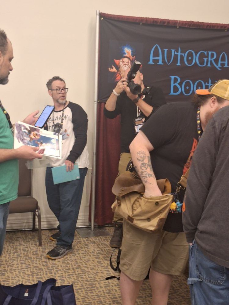 Louis hard at work during some autographs and signings.