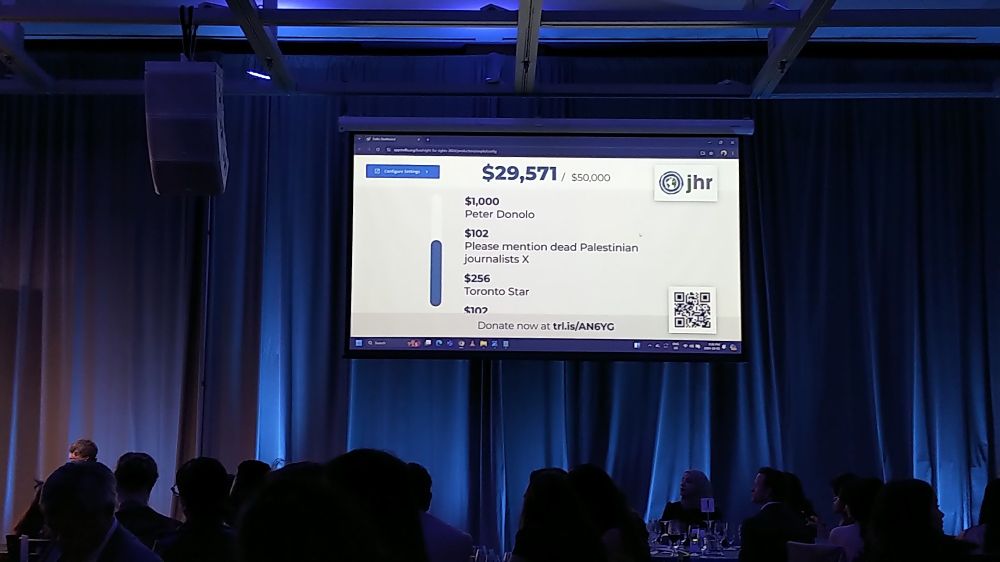 A screen showing live donations at the JHR gala. There's a donation for $102 from someone listed as "Please mention dead Palestinian journalists."