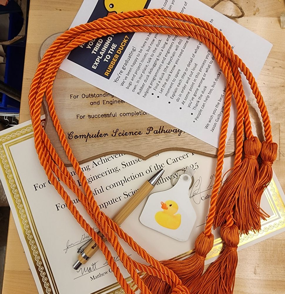 Certificate, plaque, orange cord, pen, and keychain