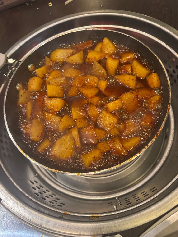Potatoes boiling in a soy-based sauce 