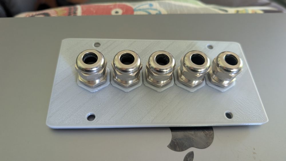 5 metal cable glands mounted in a custom 3d printed panel.