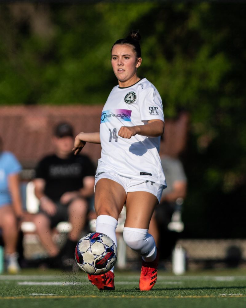 Rylee Haldeman kicking a soccer ball.
