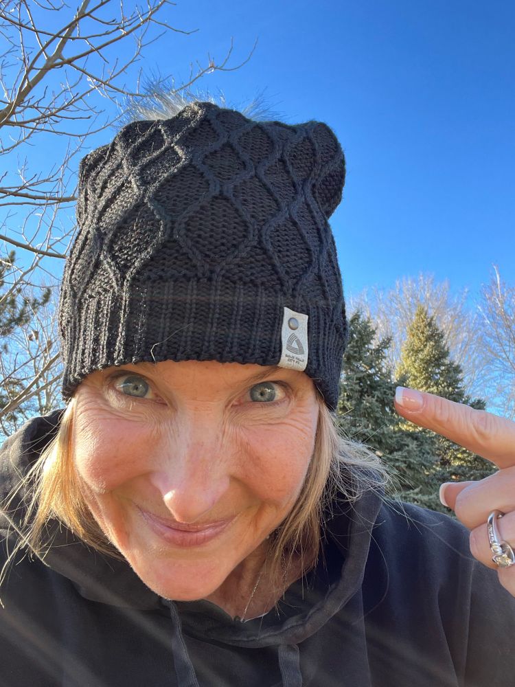 Sioux Falls City FC owner Emily Thomas wearing a black SFCFC knit winter beanie.