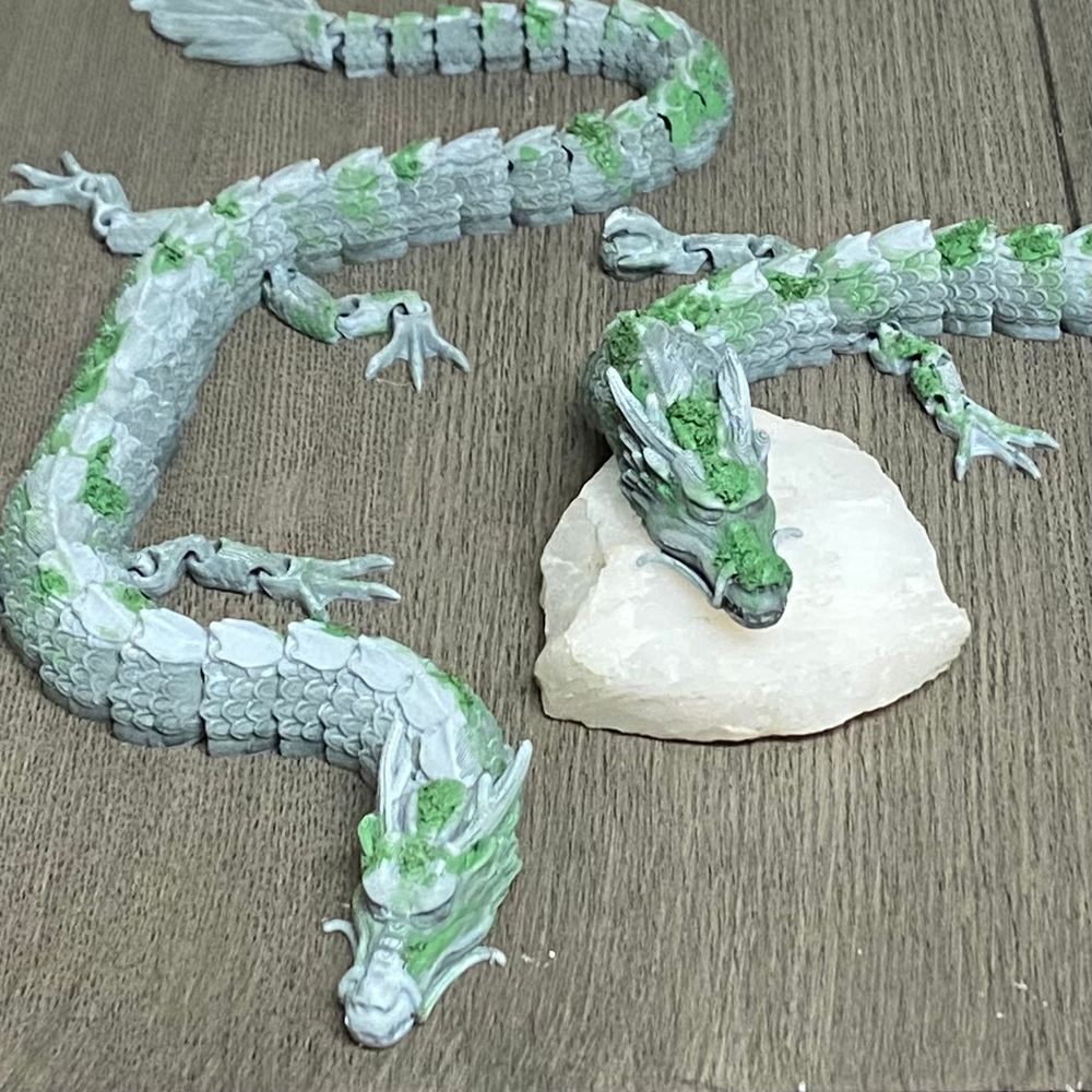 3D printed dragons painted like mossy stone