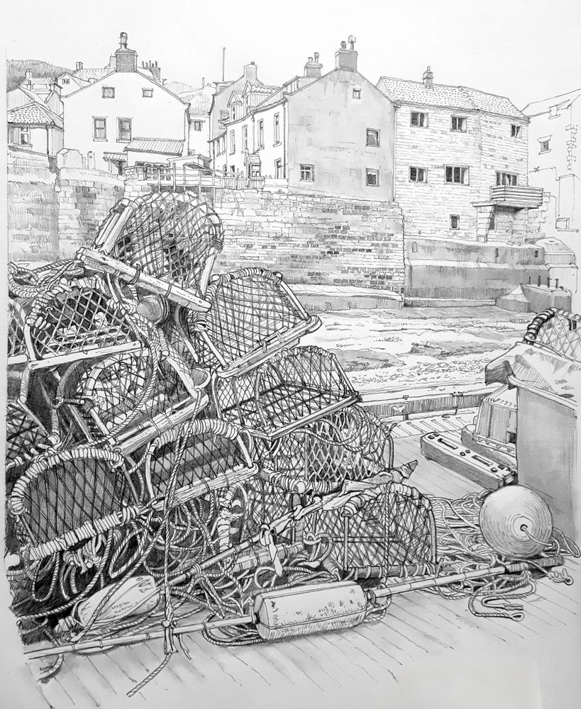 Pencil drawing of a pile of lobster pots on a harbour quayside. There are houses in the background, some of which are built on a stout sea wall. 
