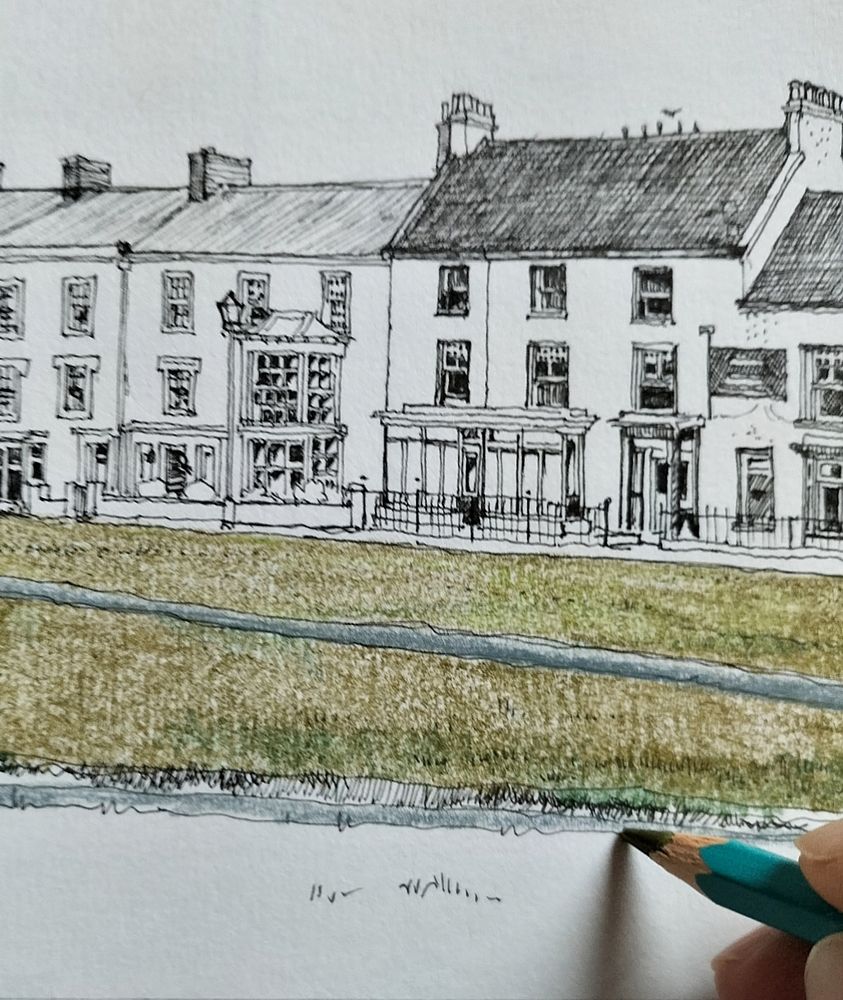 A colour pencil being used to add colour to a pen and ink sketch. 