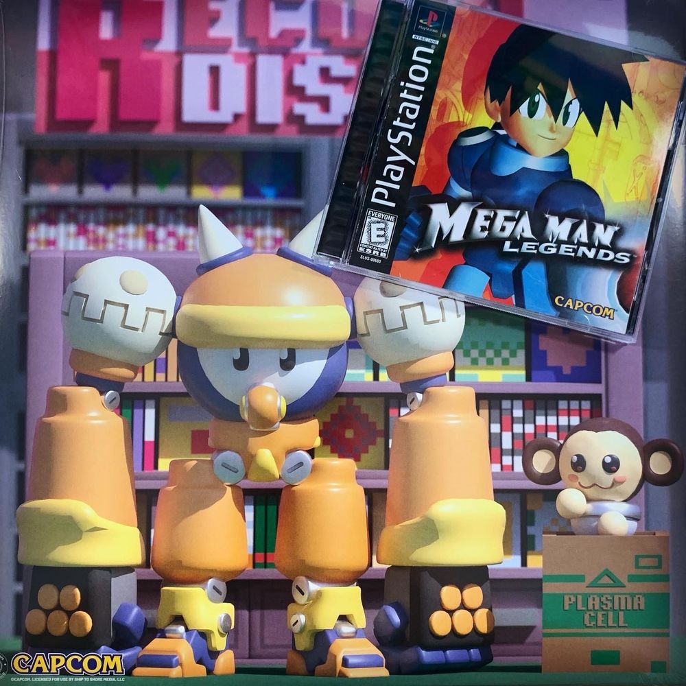 The video game Mega Man Legends on PS1 sits on top the back cover of the vinyl for the Mega Man Legends soundtrack.