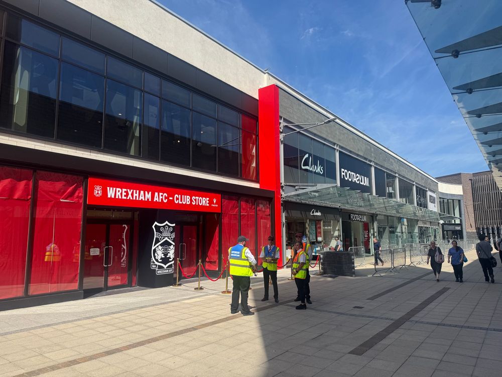 New Wrexham AFC shop, Eagles Meadow, Wrexham. 14:55 10th July 2025. It is sunny, there are security and barriers but no queue.