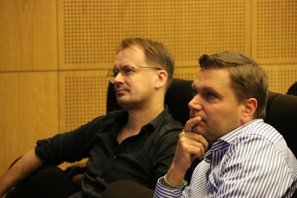 Goery Genty and Alex Heidt reflecting thoughtfully in the audience. 