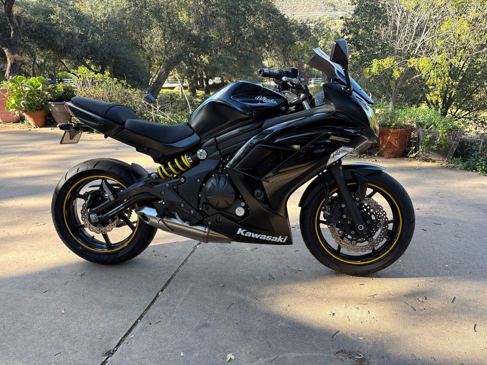 Black Kawasaki ninja motorcycle with yellow trim