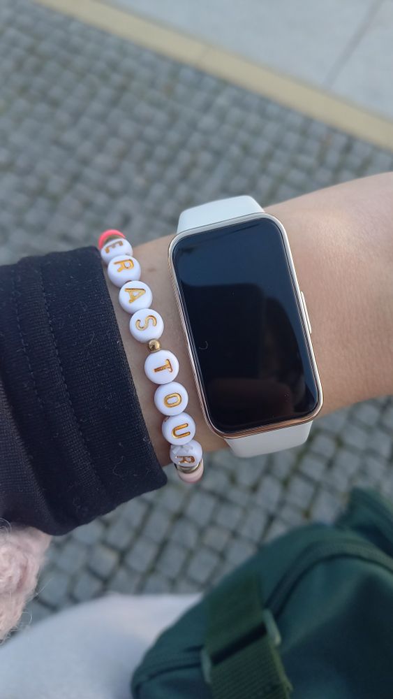 picture of arm with watch and an eras tour bracelet