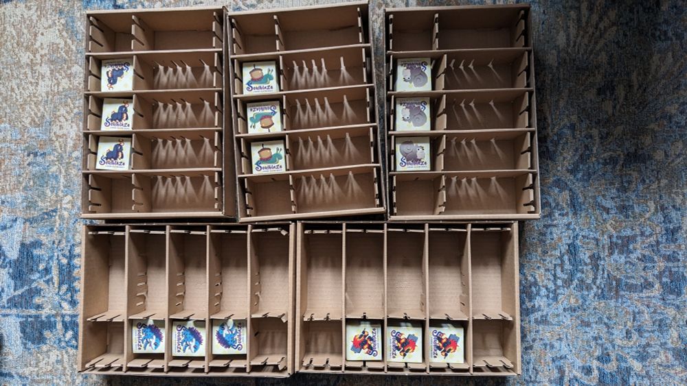Five carton boxes with each three stacks of square stickers that fill less than 30% or the box