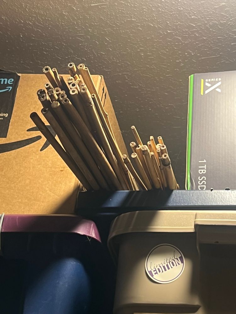 2 stacks of bamboo poles (2 different lengths)