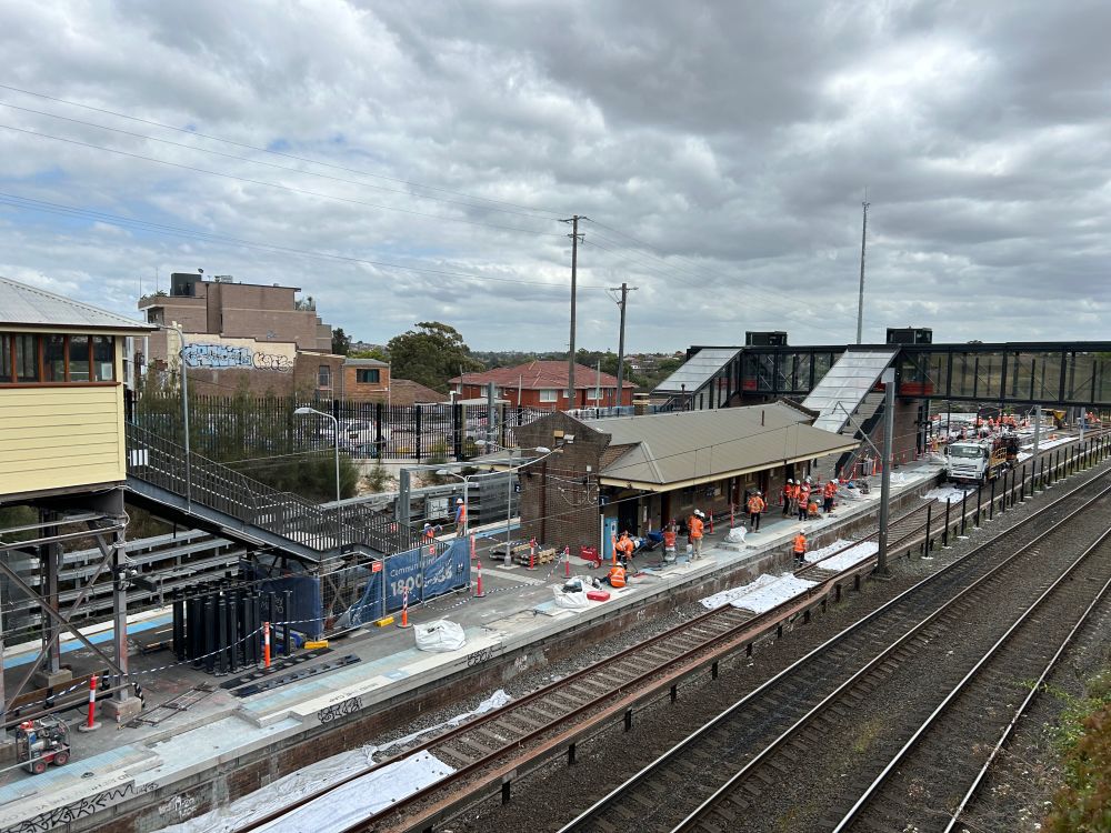 A view of Dulwich Hill Station from the Wardell Road bridge in early October 2024. Construction work is taking place on the edge of the platform.