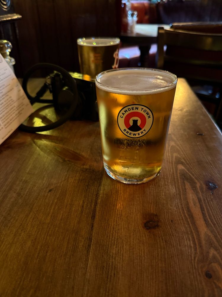 Two glasses of beer on a table in a pub