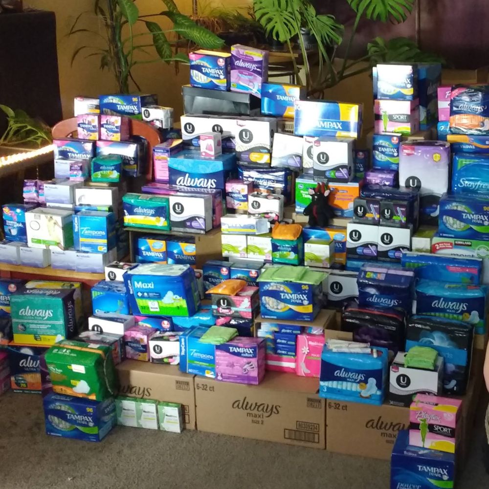 Large pile of packages of menstrual products.