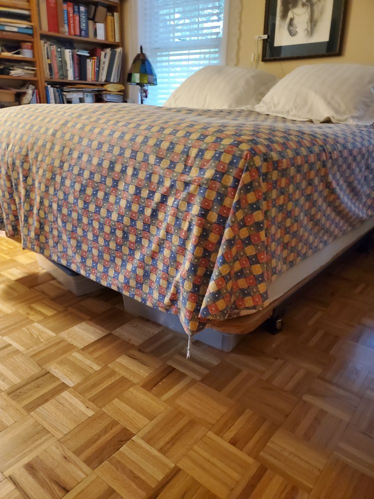 My parents ridiculously tall bed. Two queen mattresses on a raised platform bedframe. Comes up to above my waist 