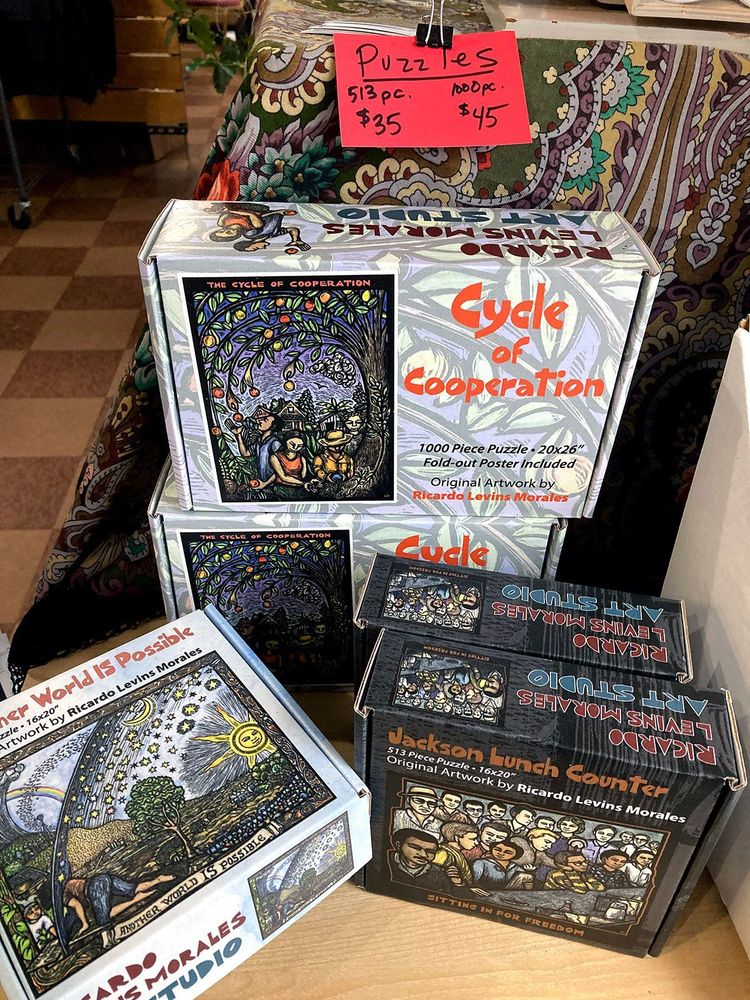 Image of several puzzle boxes stacked on top of each other. Each puzzle has a brightly colored preview image. 