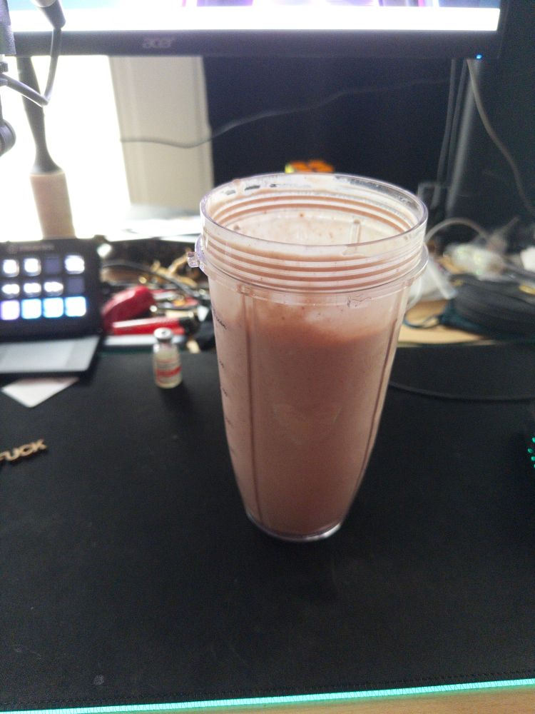 a strawberry and pb smoothie i made, on my desk, in front of my estrogen and desk mess