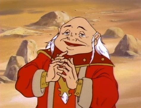 Dungeon Master from the carton Dungeons and Dragons.

Wee fella in a mostly red robe set, he's bald except for long flowing white hair from ear-level downwards.

He's looking smug (he always looked smug the bastard)
