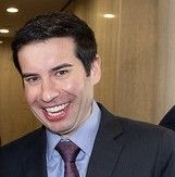 Cropped photo of Keith Sonderling at the welcome ceremony for the new secretary of labor. He is smiling jovially and has very straight teeth, dark hair and a light complexion 
