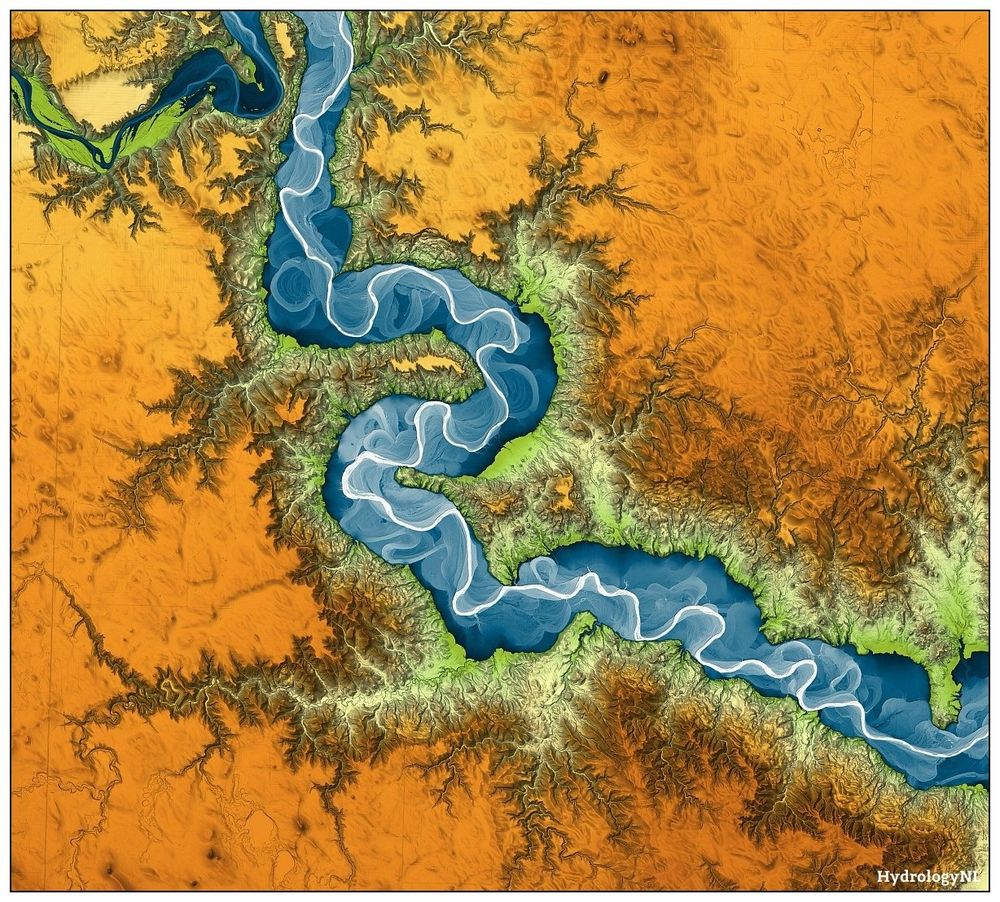 Digital elevation model of the Grand River, South Dakota, USA. River floodplain in blue (high) to white (low), the rest of the landscape in orange (high) to green (low). The river meanders, the landscape on both sides of the floodplain is eroded with finger-like gullies.