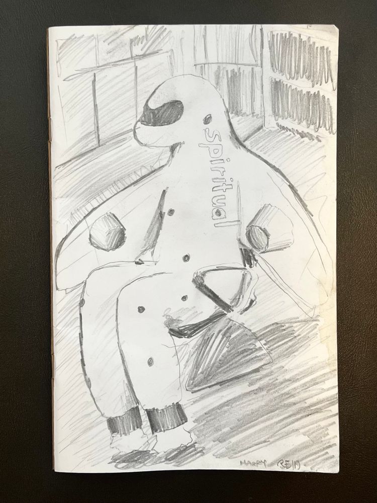 A drawing of an anthropomorphic airplane with the word Spiritual across its neck and chest sitting in the baggage claim seating of Harry Reid International Airport