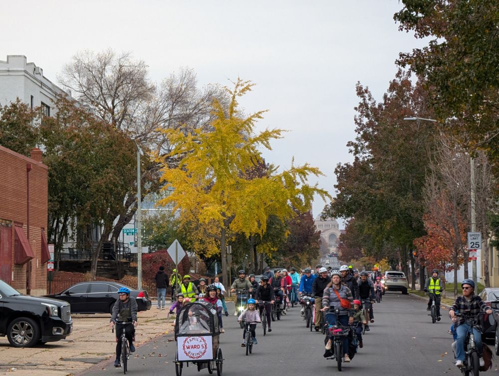 Photo of the November Ward 5 Family Bike Ride ending at Lost Generation on 11/15.  It's a mix of people riding cargo bikes, adults on bikes, kids on bikes, lots of marshal support.