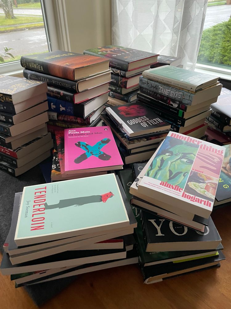 Huge stacks of books by women 
