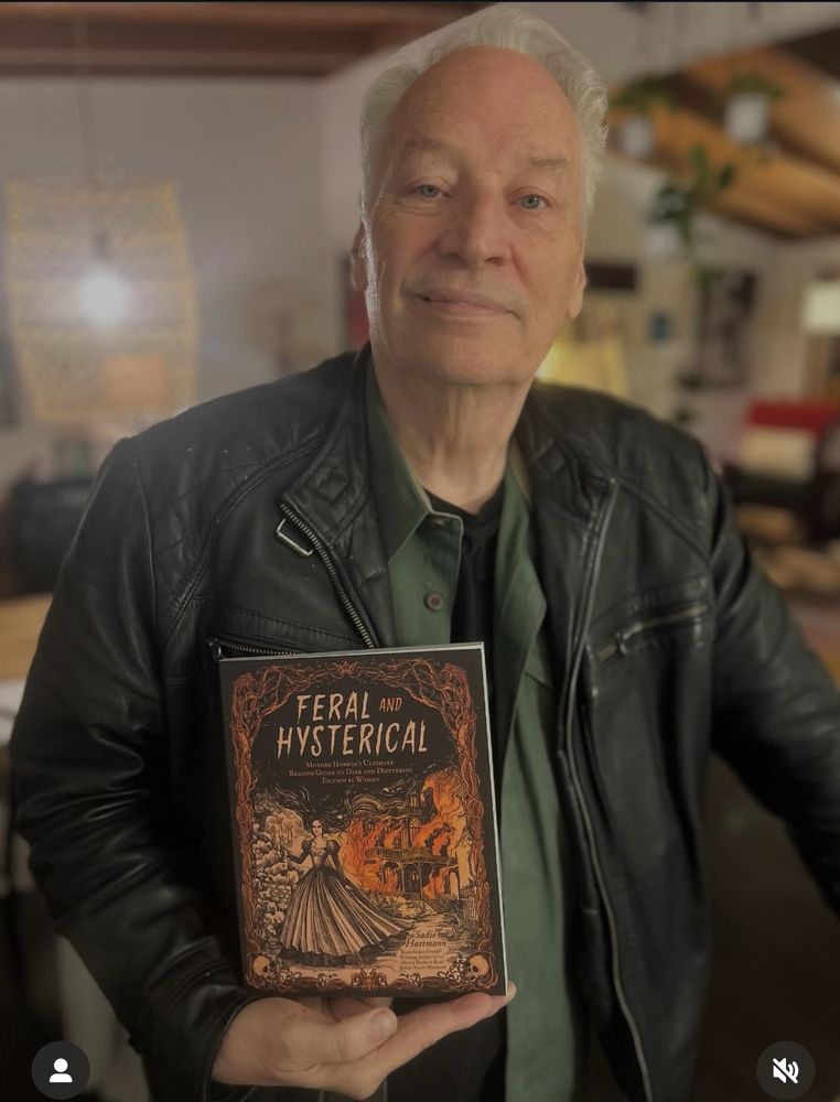 Joe R Lansdale holding Feral & Hysterical 