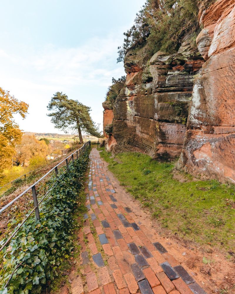 A brick path running alongside the red sandstone rocks