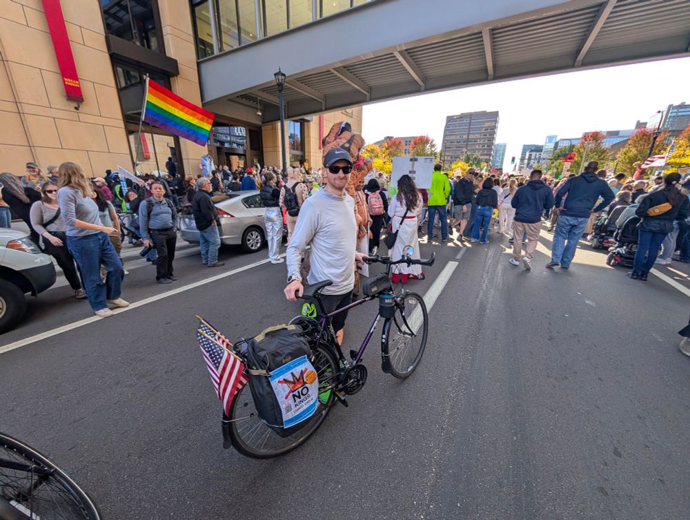 Some dude at the No Kings Minneapolis rally with a sweet 90's Trek Multitrack Sport 700 RestoMod that's decked out with flags and stuff.