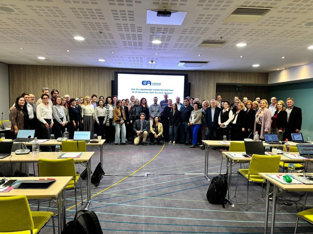 Photo of the attendees of the European co-operation for Accreditation (EA) Laboratory Committee meeting. Photo shows group of people in front of a screen with the EA logo. Image credit of EA