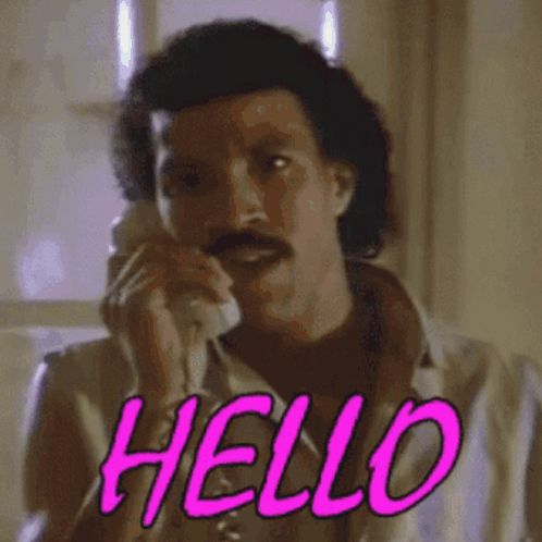 a man with a mustache is talking on a phone and the word hello is visible